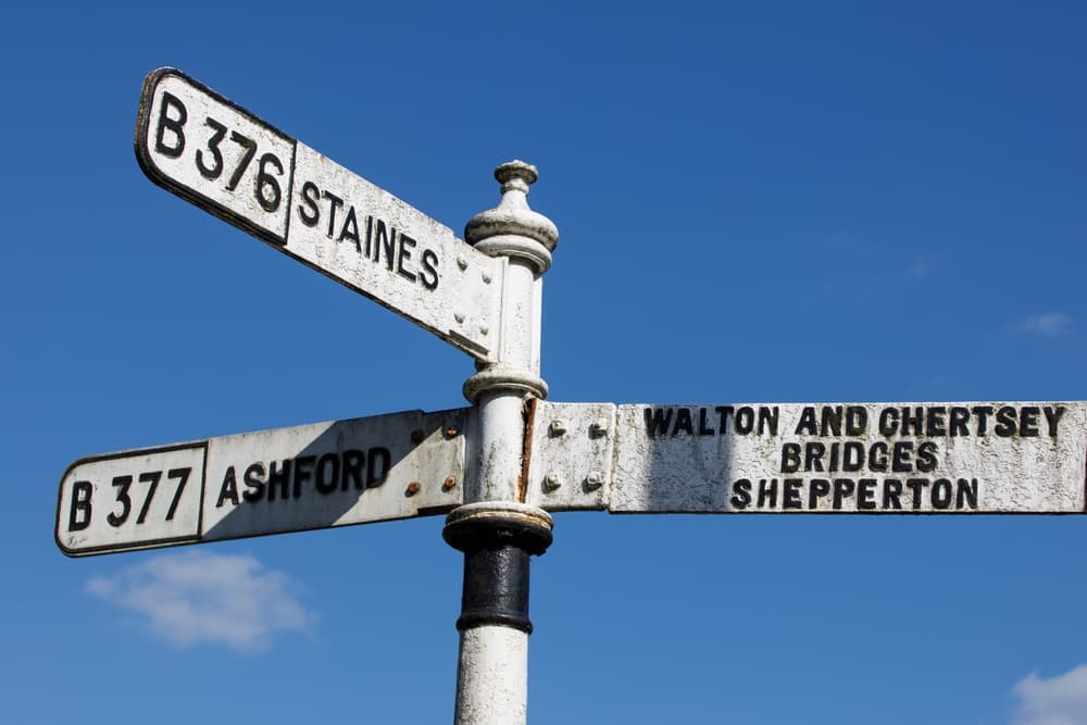 A traditional road sign pointing to Ashford