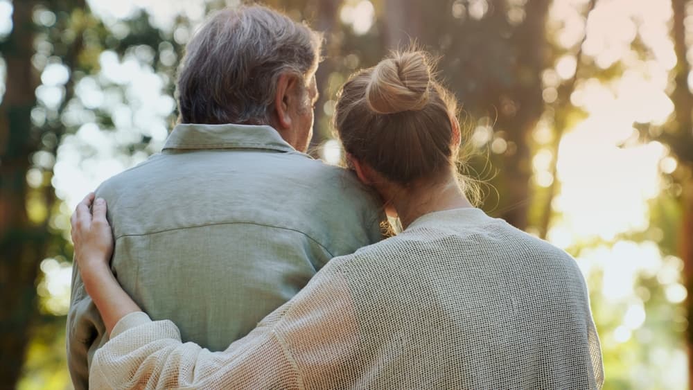 A father and daughter embracing outdoors